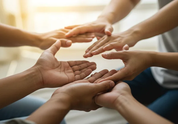 Supportive hands reaching out for a safe, accepting space.